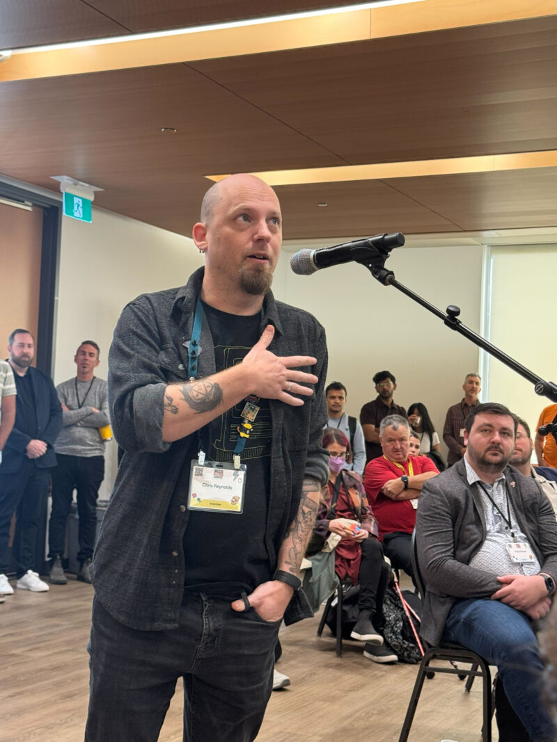 Chris Reynolds asking Matt Mullenweg a question at the town hall at WordCamp Canada 2025